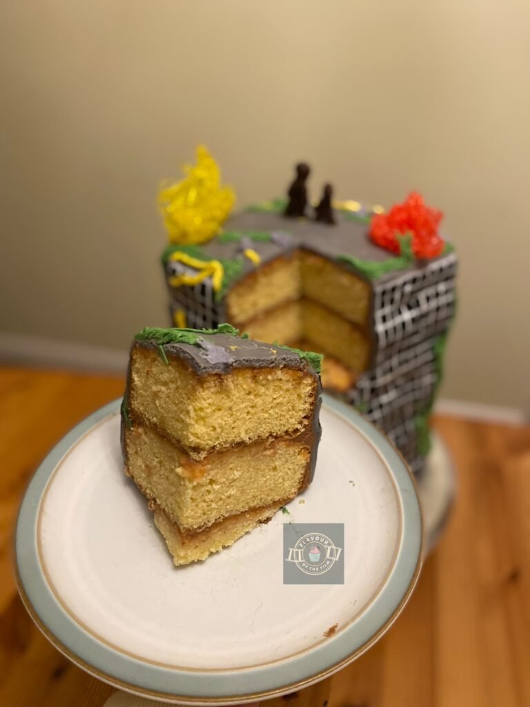 All images are of a The Last Of Us cake that is built and decorated to resemble a derelict skyscraper, with grey fondant as the exterior, hand painted windows, piped fungus in yellow, green and purple, and isomalt fungus in yellow and red on the top of the cake. Plus, brown fondant silhouettes representing the main characters stood on the very top of the cake.