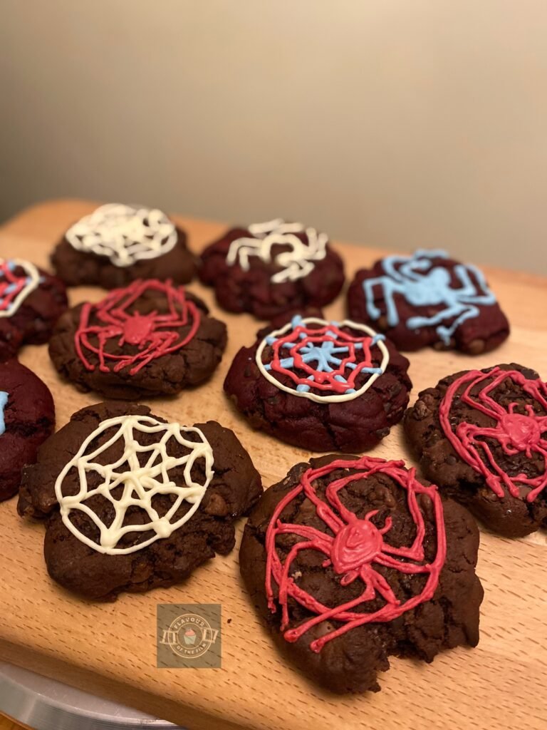 Triple chocolate NYC cookies with vivid piped decorations in spiderweb and Spider-Man insignia imagery. These NYC cookies celebrate Spider-Man: Into the Spider-Verse but make a great addition to this movie night checklist.