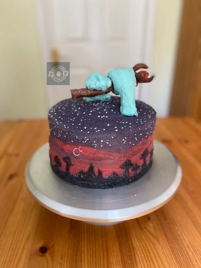 All images are of a three layer birthday cake decorated like a sunset, with silhouette mushroom shaped buildings, two crescent moons in white and white stars. The cake is topped with two blue hands made from modelling chocolate and a chocolate wizard's staff with a candy phoenix gem. The cake celebrates Disney Pixar's Onward.