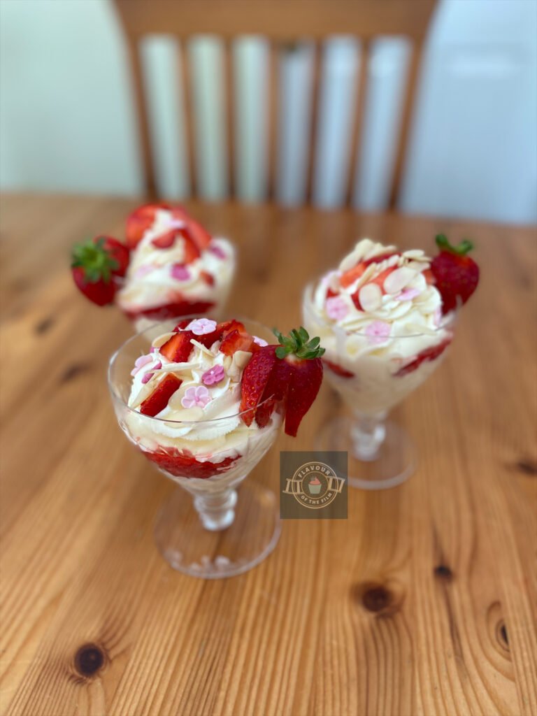 All images are of vanilla sundaes in glasses, topped with whipped cream, strawberry pieces and flaked almonds. Each one is finished with pink cherry blossom candy pieces and an individual whole strawberry garnish on the edge of the sundae glass.