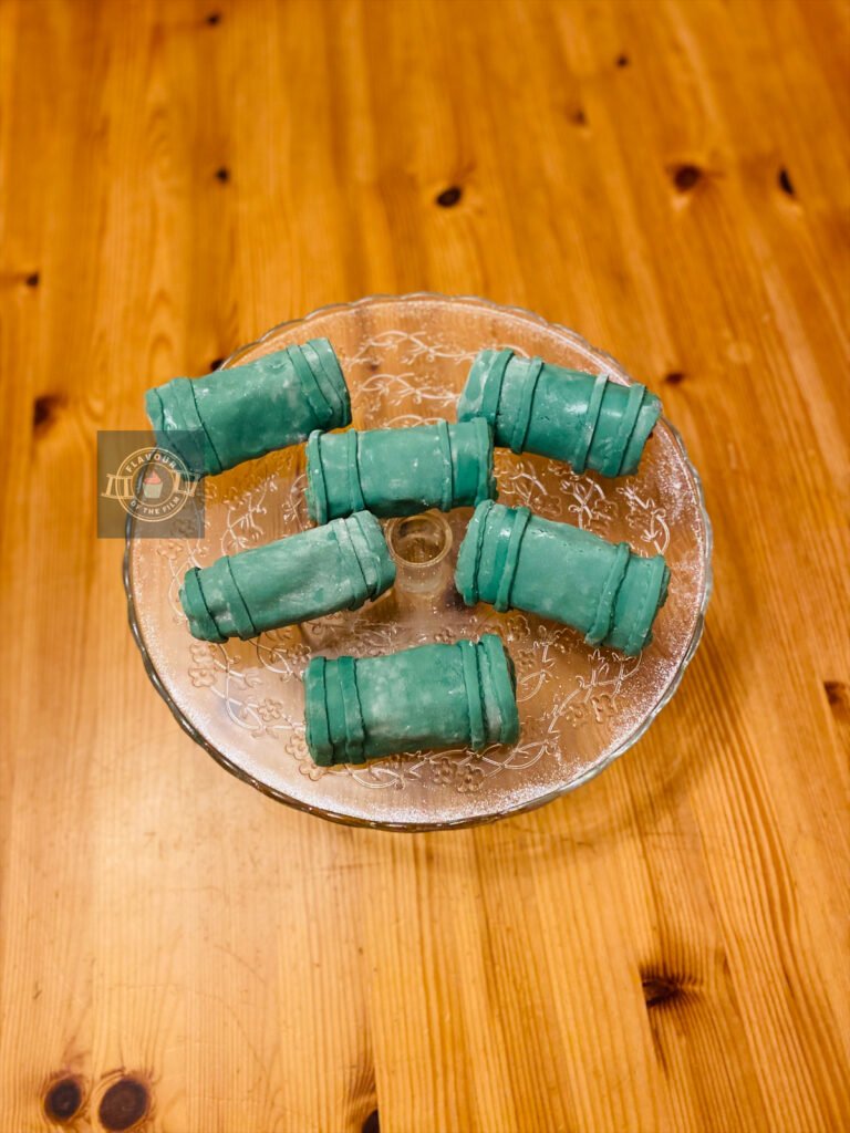 All images are of vanilla sponge cake rolled up and filled with strawberry jam and vanilla buttercream. They cake rolls are decorated with green fondant to resemble bamboo pieces. These Japanese strawberry cake rolls celebrate the Anime known as Demon Slayer.