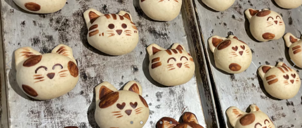 Cat (head) shaped biscuits with varying cute expressions that are hand painted from Cat & Bakes 9456.