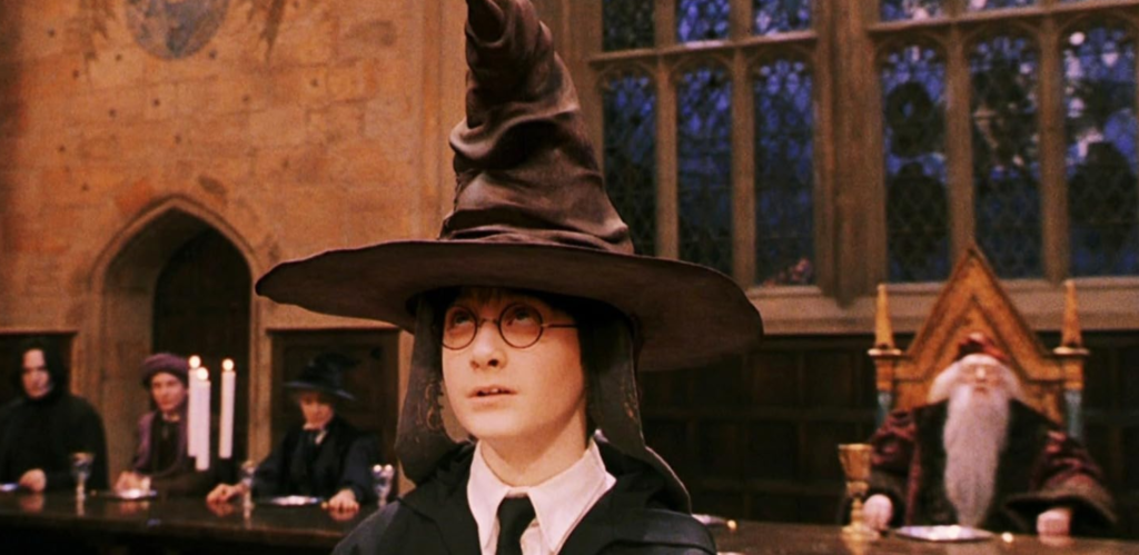 Harry being sorted into a Hogwarts house by the sorting hat.