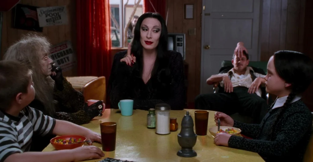 The Addams family having breakfast together.