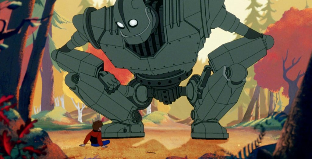 The iron giant crouching down in a forest, interacting with his new friend.