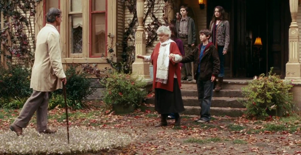 Simon, Jared and Mallory walking their grandmother to her father who is walking with faeries supporting his weight beneath his feet.