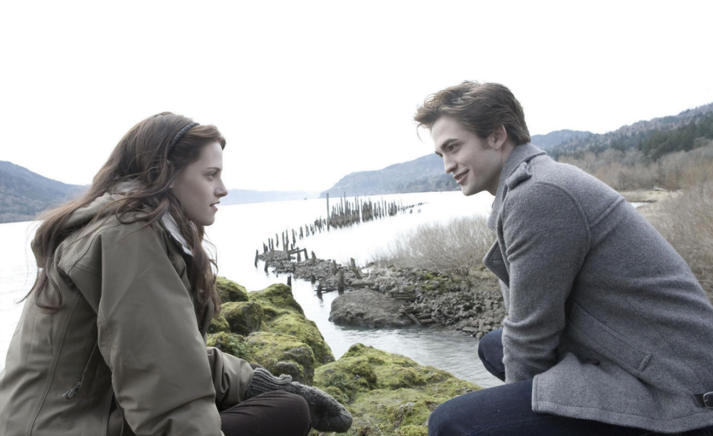 Bella and Edward talking outside by a lake.