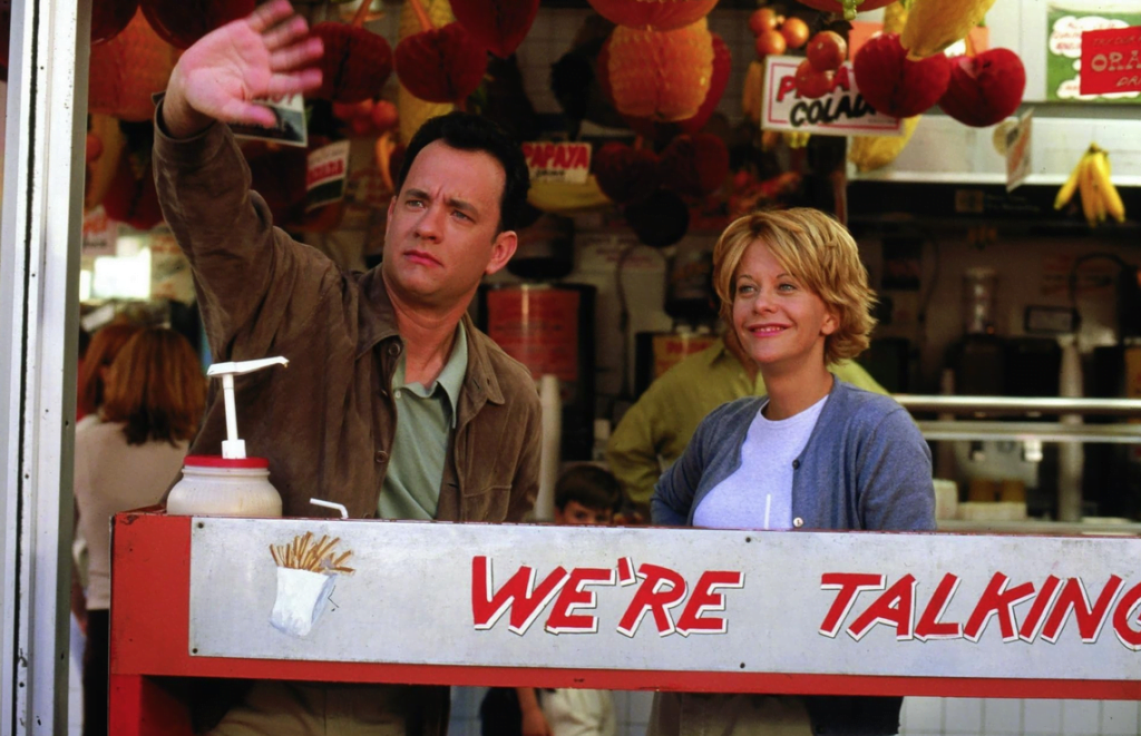 Joe and Kathleen behind a counter at Gray's Papaya, having hot dogs for lunch.