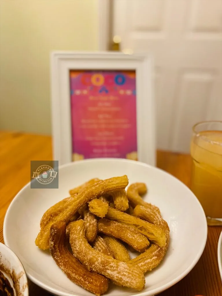 Homemade churros in a dish.