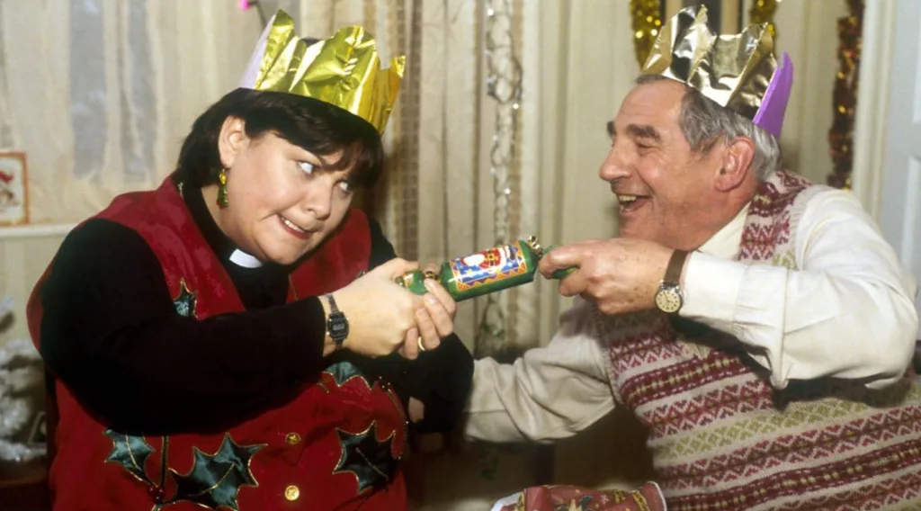 Geraldine and Jim pulling a Christmas cracker.