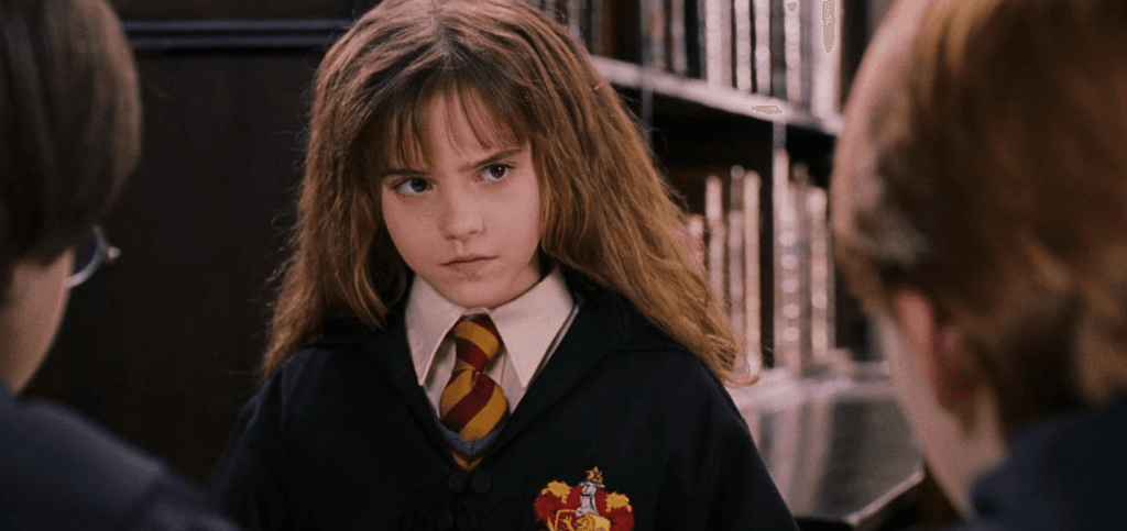 Hermione giving Ron a stern look when he judged her for calling a large library book "light" in Harry Potter and the Philosopher's Stone.