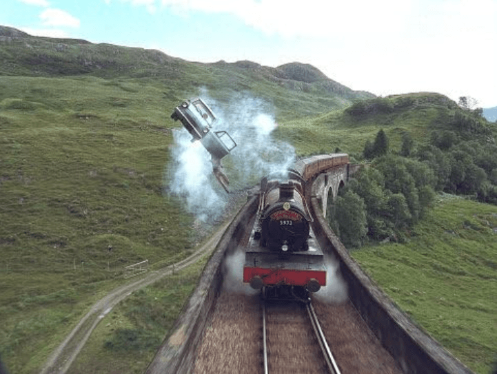 The flying car over the Hogwarts Express as it travels over the viaduct.