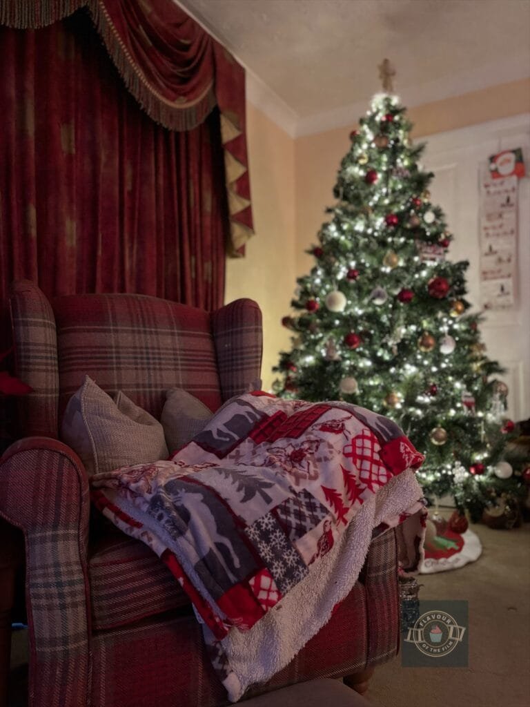 Cosy Sherlock chair with festive blanket by the Christmas tree.