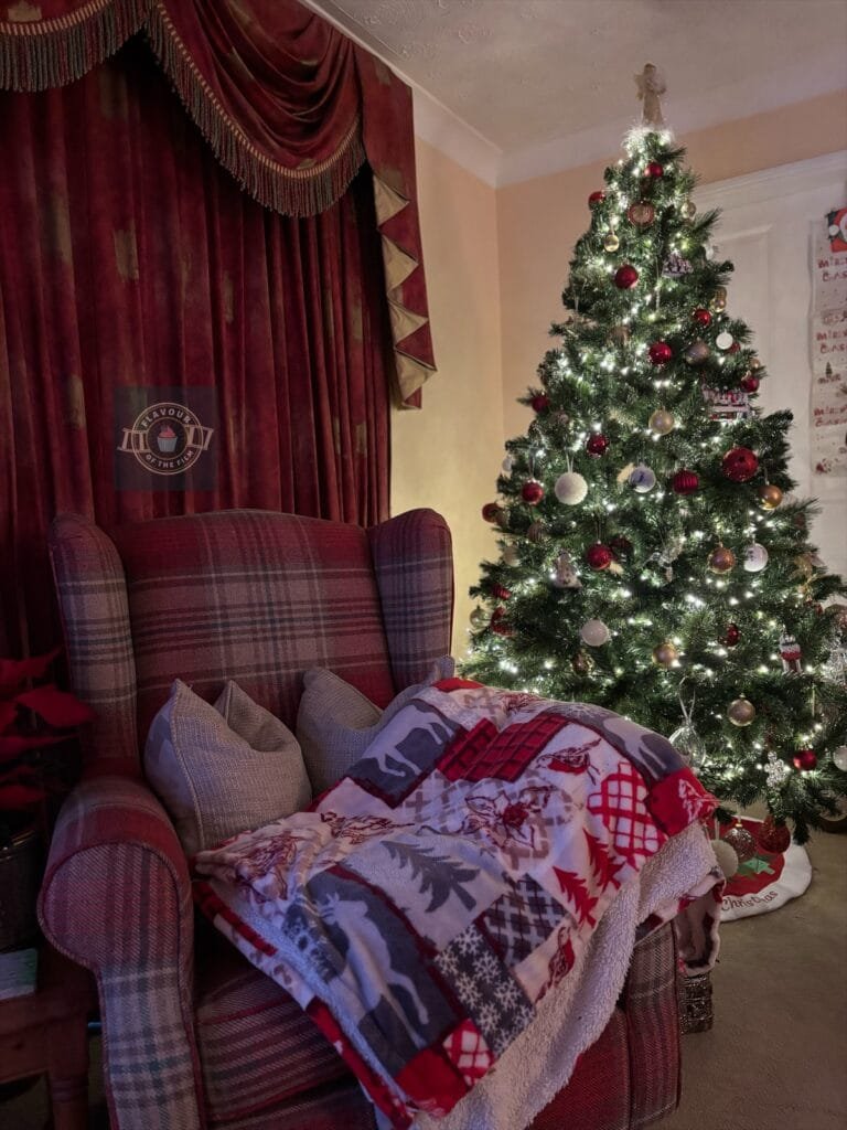 Cosy Sherlock chair with festive blanket by the Christmas tree.