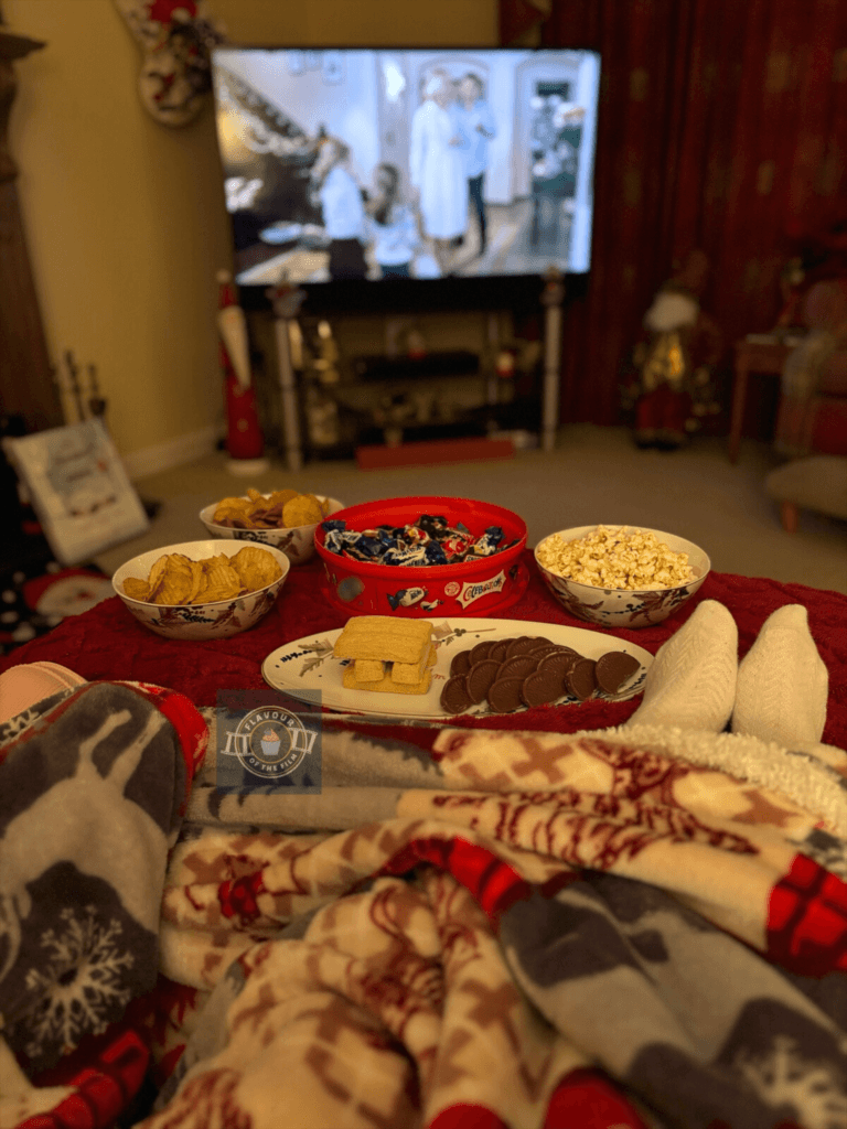 Cosy with festive snacks and The Holiday on TV.