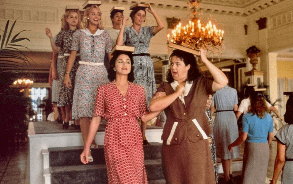 The ladies of the baseball team dressed up and practicing their posture.