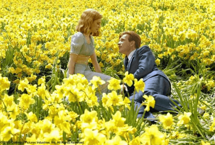 The two main characters in a field of daffodils.