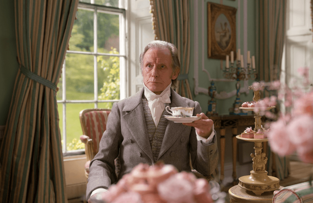 Bill Nighy holding a teacup.