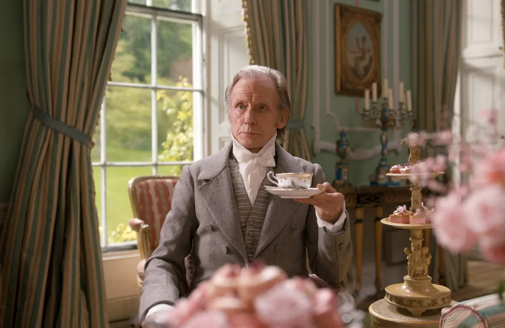 Bill Nighy holding a teacup.