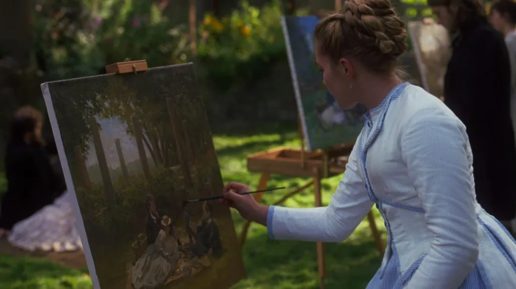 Amy outside painting a landscape picture.