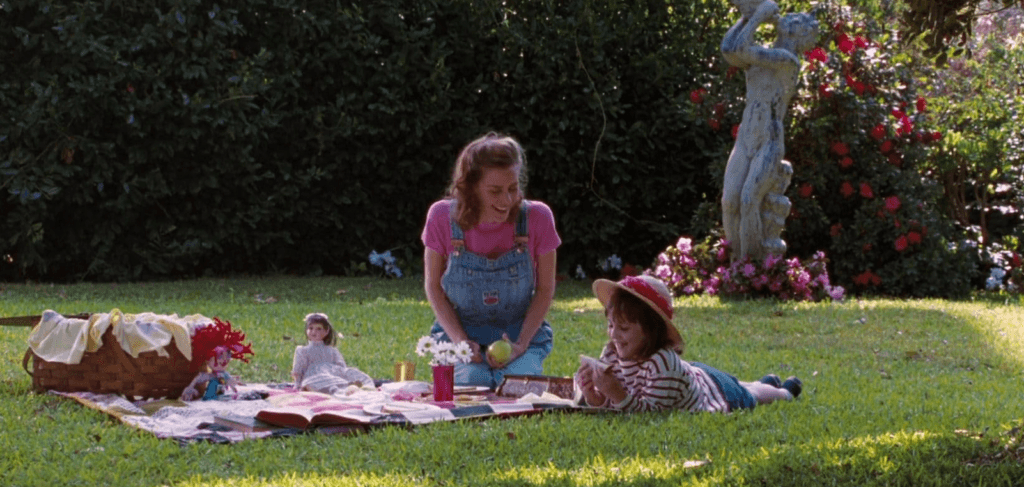 Matilda and Miss Honey enjoying a picnic in their back garden (end montage).