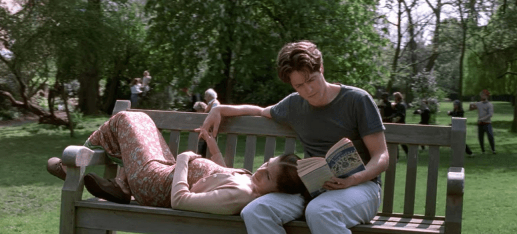 The main characters on a bench at the end of the movie, enjoying each others' company and the weather.