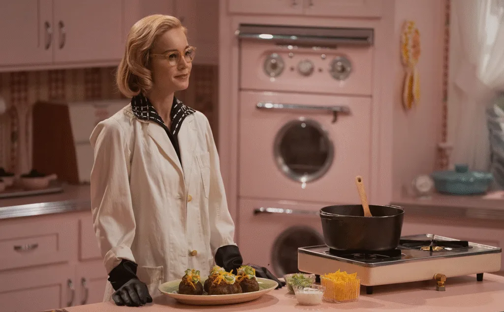 Elizabeth in her white coat in her TV kitchen.