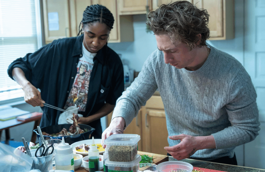 The lead characters preparing food.