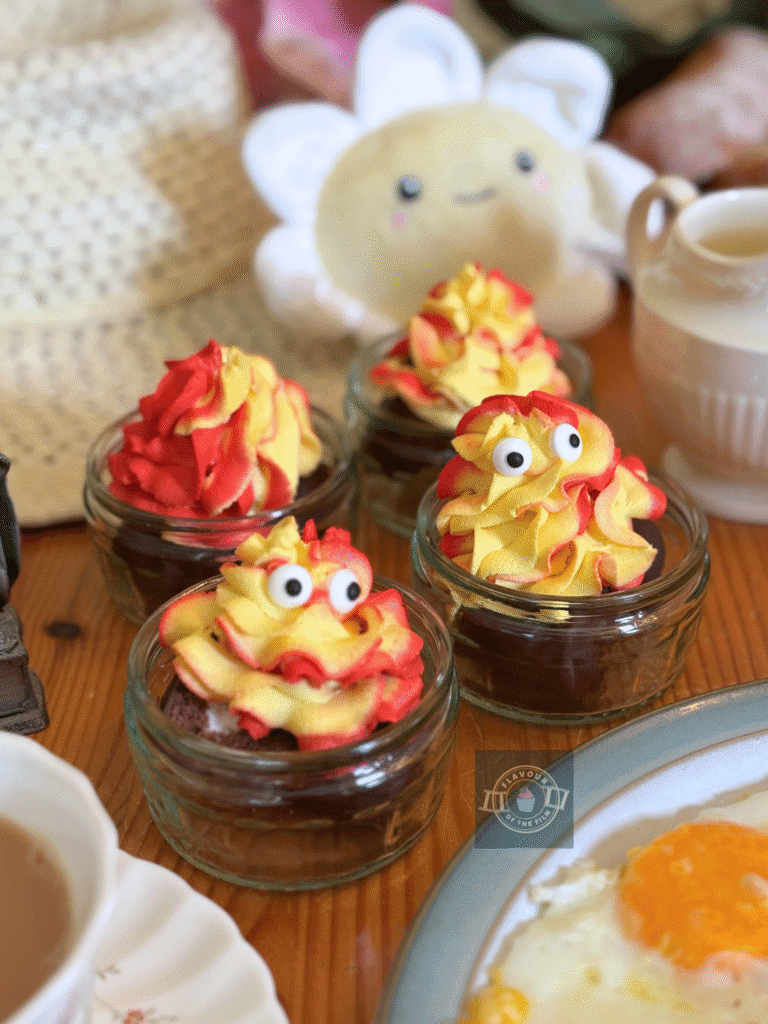 Chocolate mini rolls served in ramekins and topped with red and white swirled whipped cream with candy eyes.