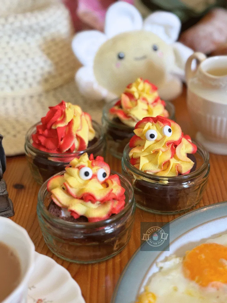 Chocolate mini rolls served in ramekins and topped with red and white swirled whipped cream with candy eyes.