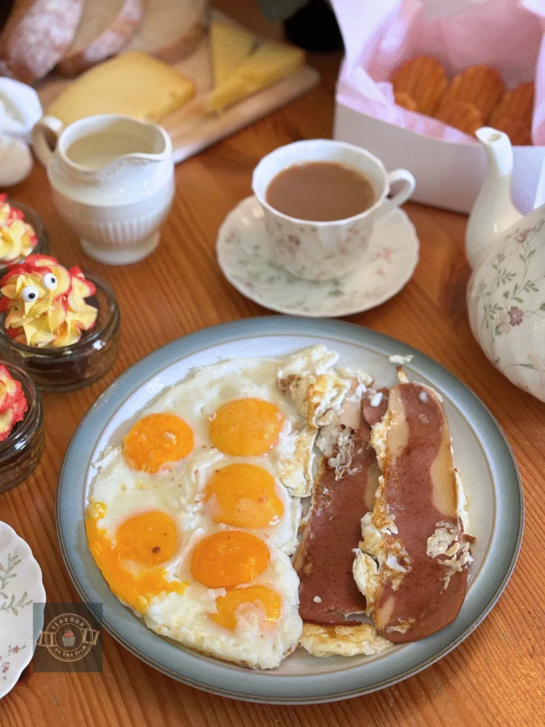 Fried eggs and fried veggie bacon served on a plate.