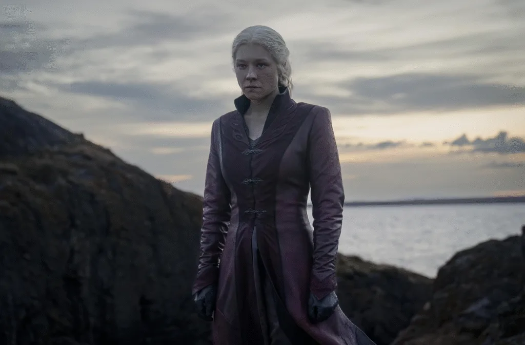 Rhaenyra standing strong with the ocean behind her.