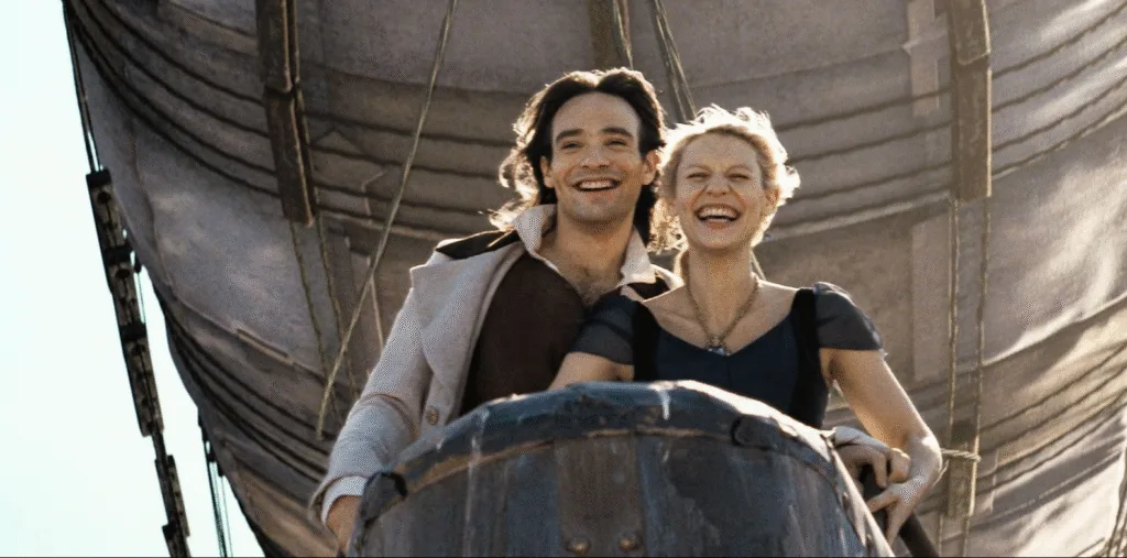 The lead characters on the air ship smiling.