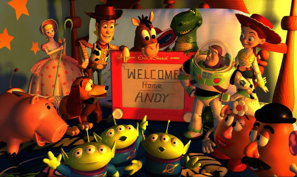 The toys stood with an etch-a-sketch that says "welcome home Andy" on it.