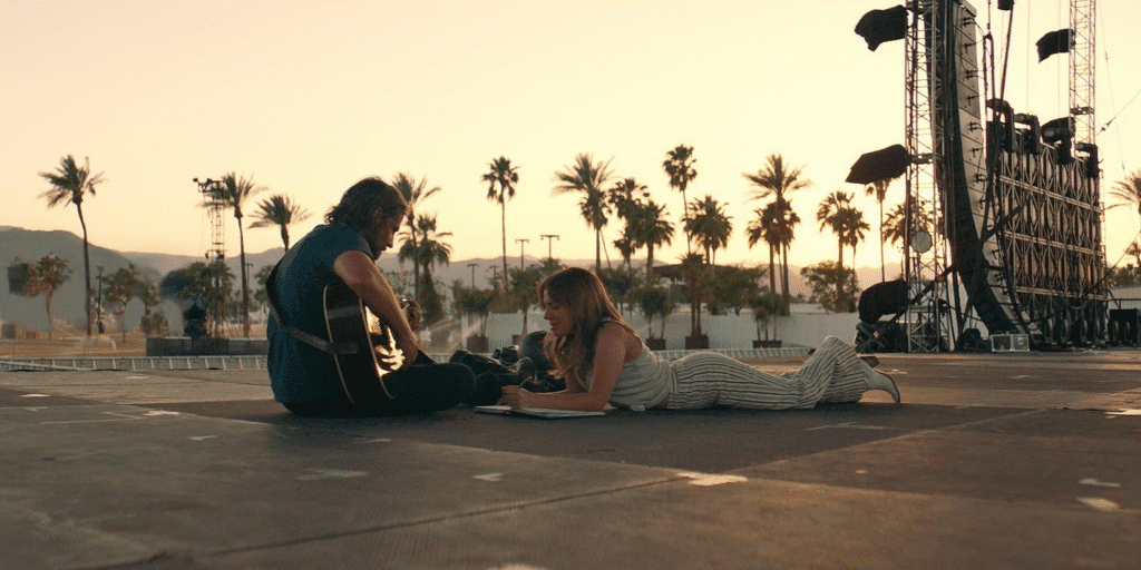 The lead characters writing songs on stage.