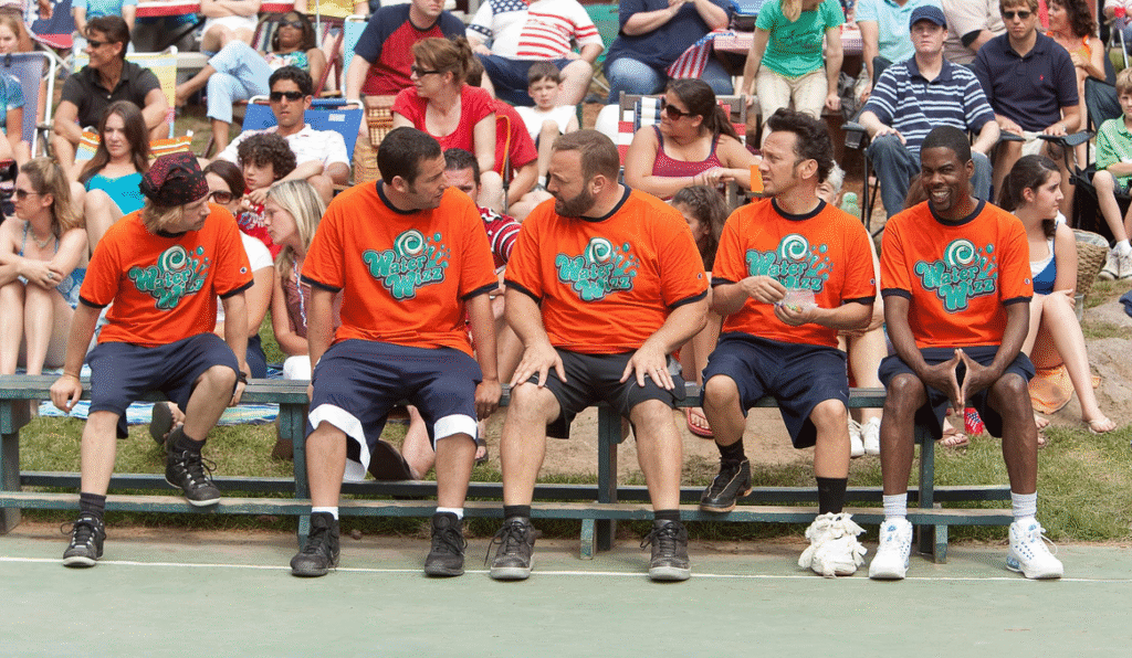 The group on the bench beside a basketball court.