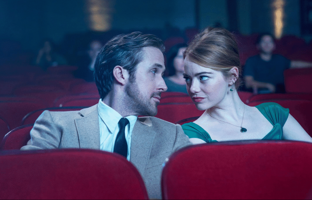 The two main characters sitting in the cinema.