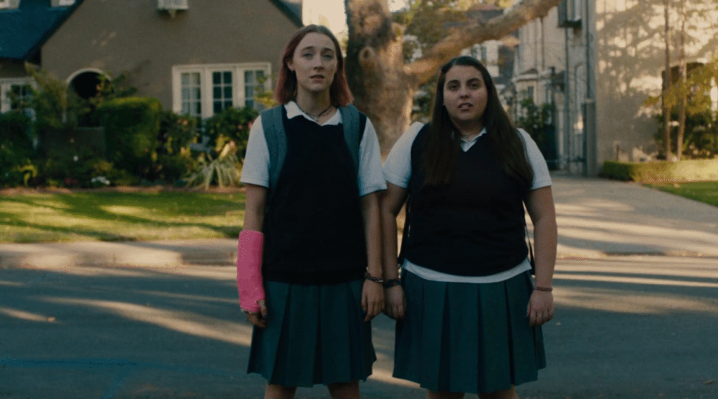 Lady Bird and her best friend admiring a house.