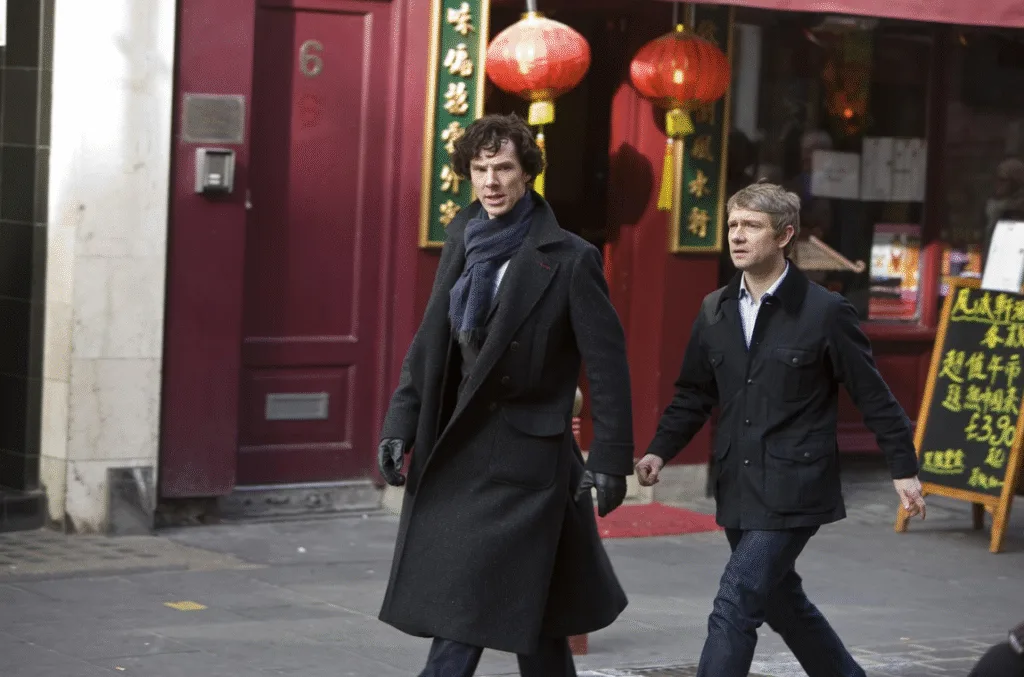 Sherlock and John striding through Chinatown.
