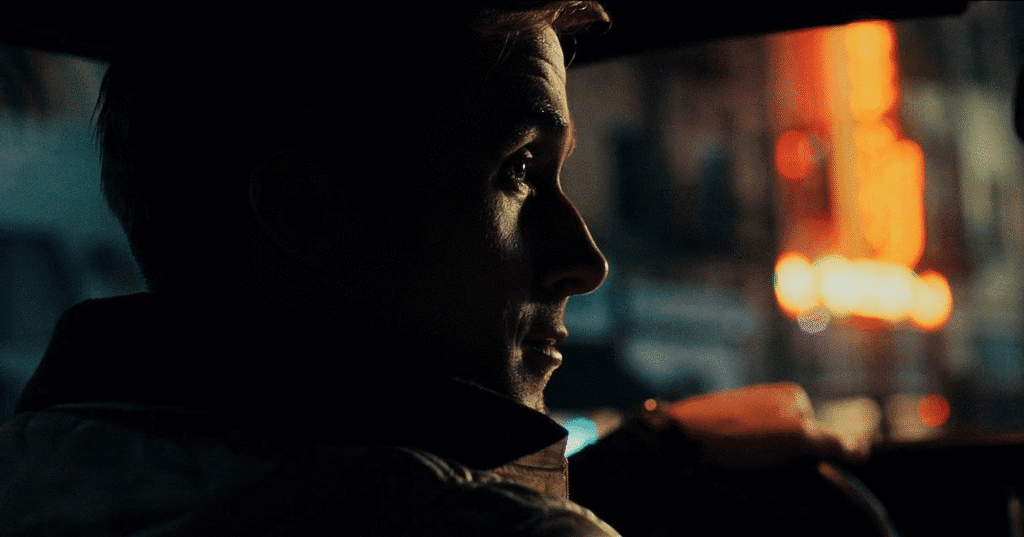 Close up of Ryan Gosling's face in a car at night.