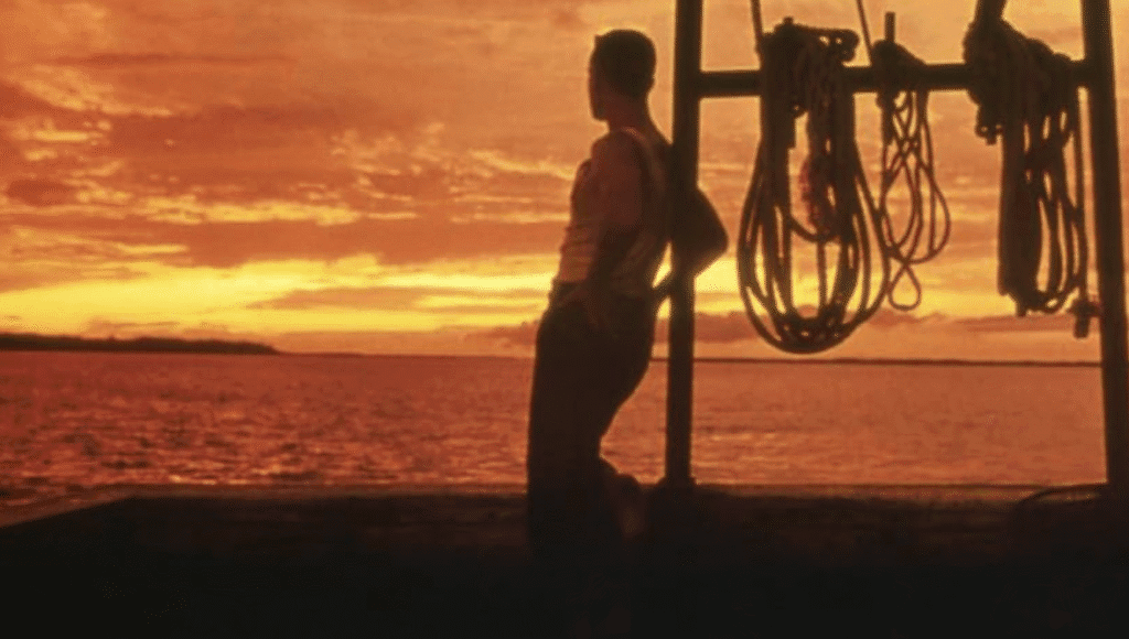 Forrest watching the sun set on whilst his boat.