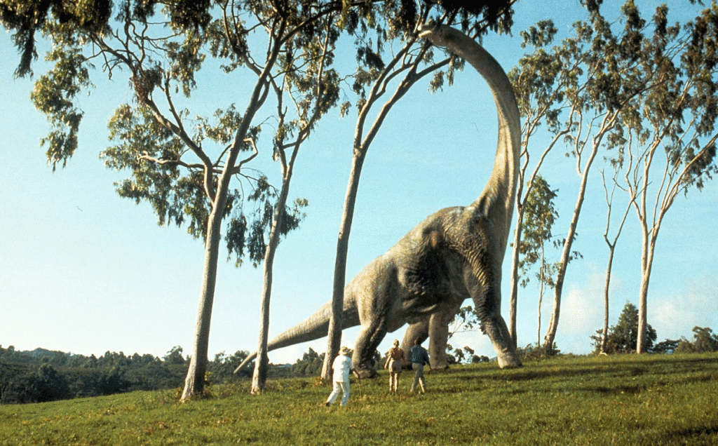 The main characters walking up to a dinosaur.