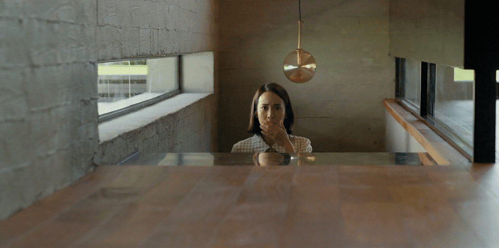Home owner shocked with her hand over her mouth as she walks up the stairs.