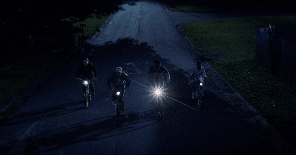 The kids on their bikes in the dark with torches to light their way.