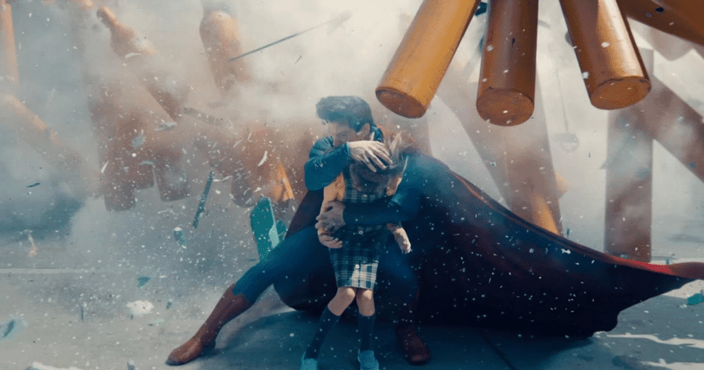 Superman saving a young girl from an explosion.